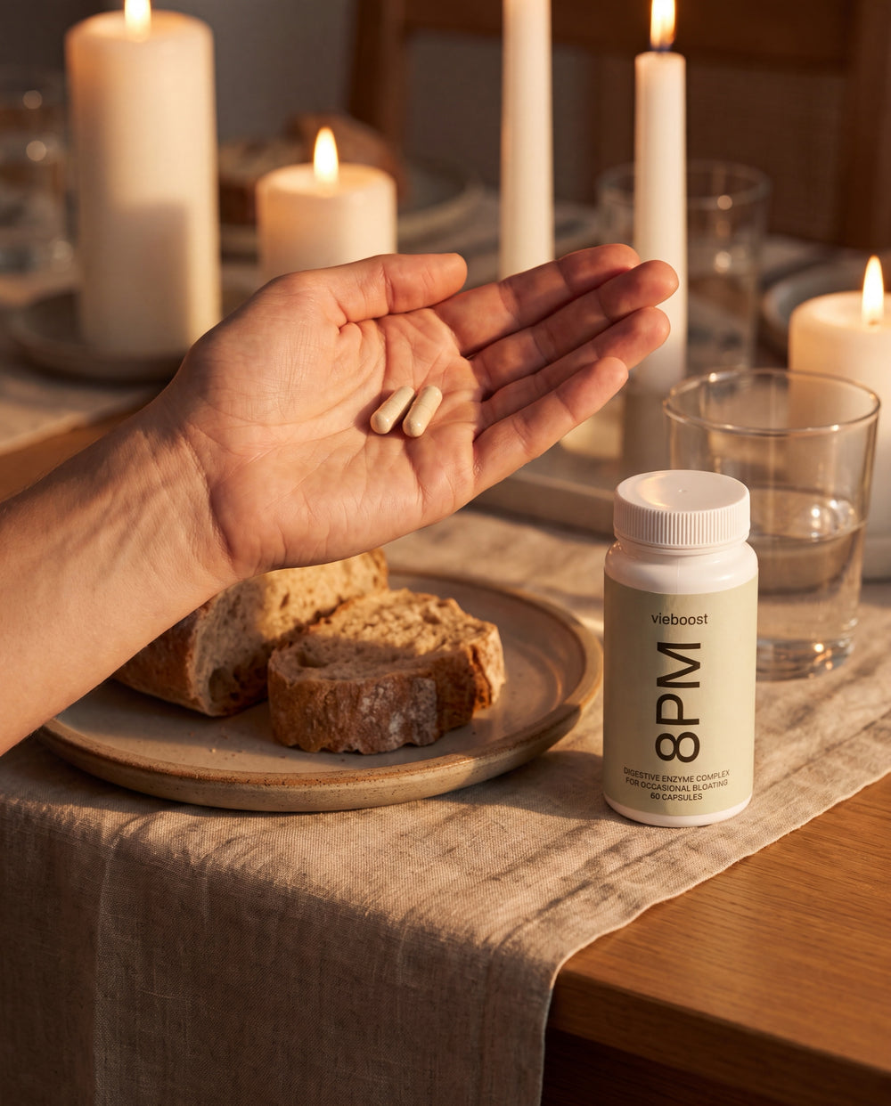 Two 8PM capsules in hand at the dinner table