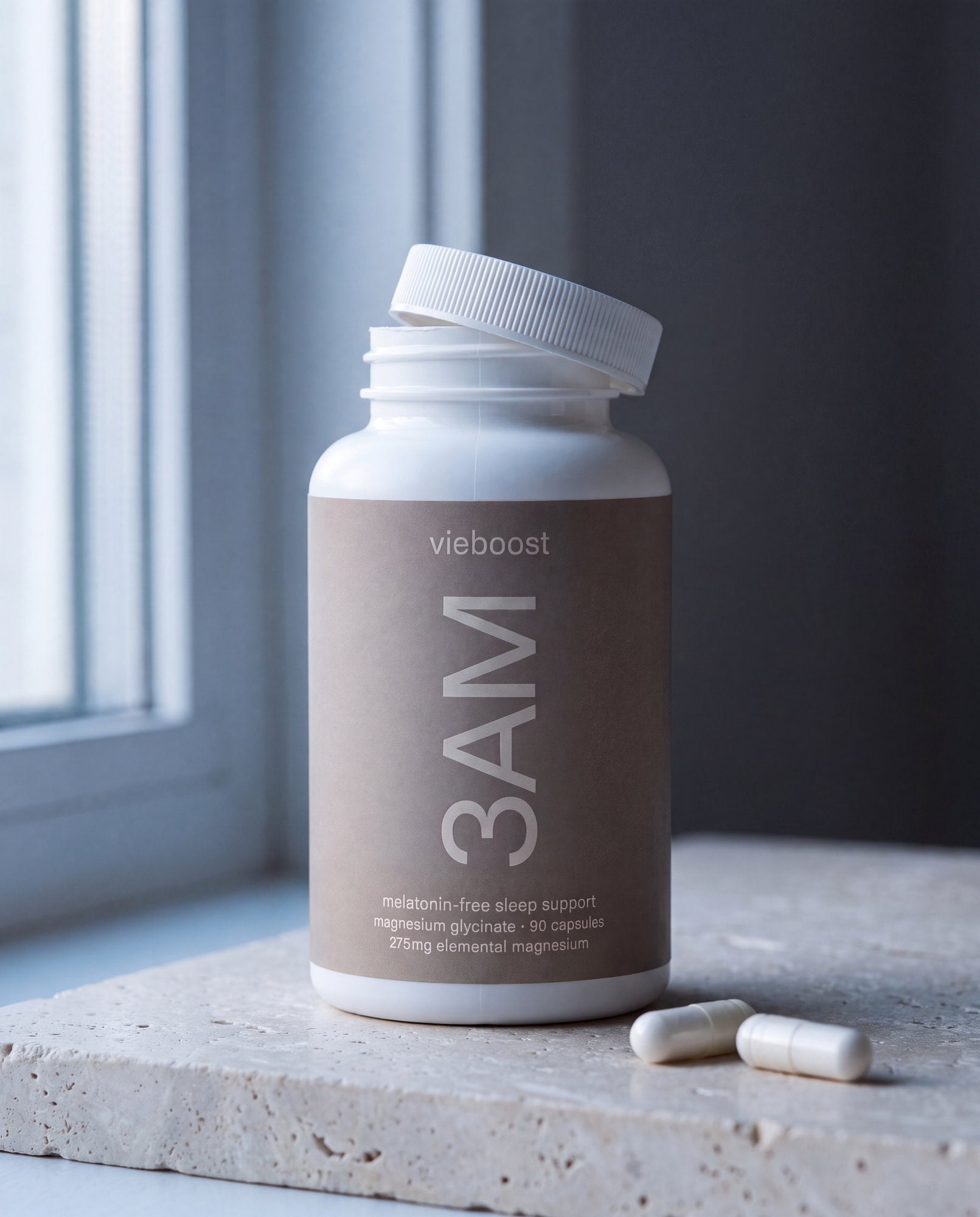 3AM™ ingredient still life — bottle and magnesium glycinate capsules